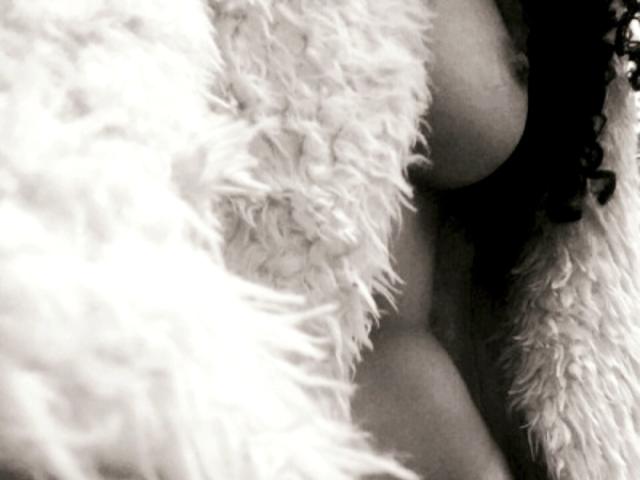 MarieNShantal's tits are partially covered by fluffy white fur, with her nipples slightly visible. The image is a black-and-white, fuzzy photograph.