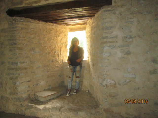 FacialEjac with medium tits, wearing a black top, ripped jeans, and sneakers, standing in a stone room with a wooden ceiling, holding her phone, dated 10/09/2016.