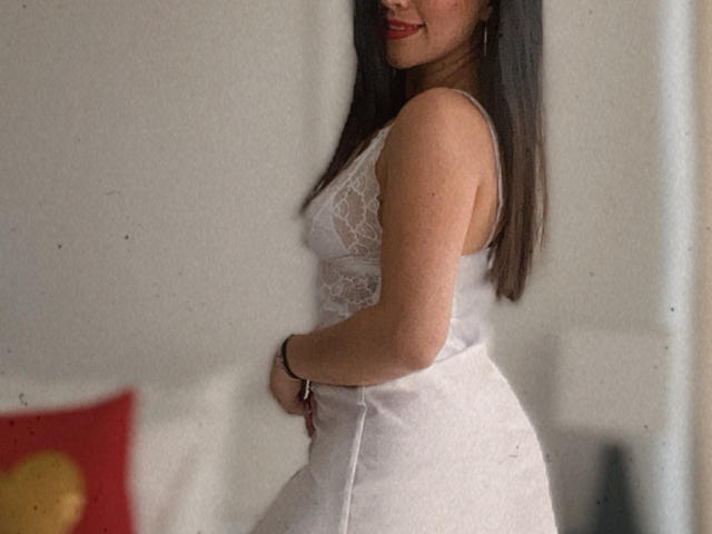 A flat, stylized emblem with a bold, red center and dark edges. The emblem has a subtle, slightly raised texture. Simple, geometric design. The emblem is centered.