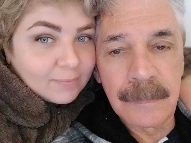WildLatinCouple has a cute face with blue eyes and light brown hair, wearing a fuzzy brown jacket. WildLatinCouple's gray-haired, mustached older partner is next to them.