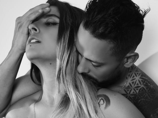 KendraWaltonJeffLuthor's face is partially covered by JeffLuthor's hand, kissing her neck with his beard and tattooed arm visible. Her long, blonde hair and nose ring are prominent.