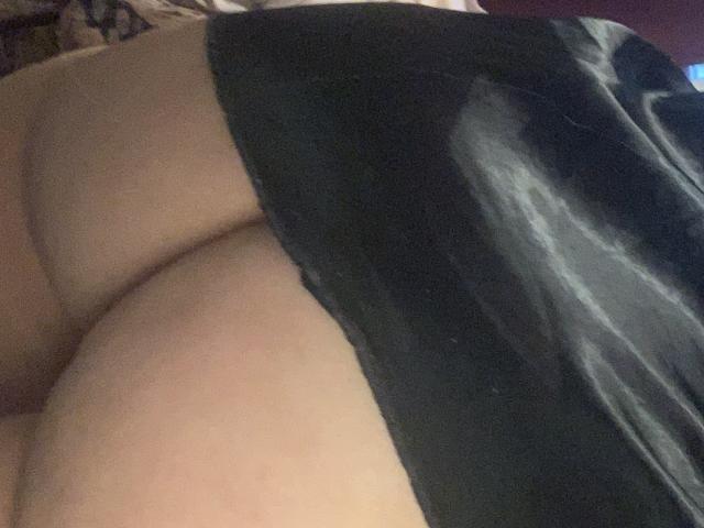 QueenKaly's ass in black lingerie, showing her bare butt and upper thighs, with a slight shadow on the right side. The photo is taken from a side angle.