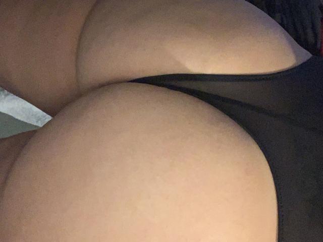 QueenKaly's large, round ass in black sheer underwear, with her smooth, tan skin and curvy, voluptuous body prominently featured in the tight, intimate shot.