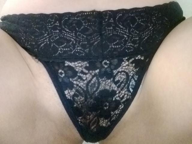 ValentinaAnal's black lace panties are snug on her pussy, featuring intricate floral patterns and a lace band at the top. Her pale skin is visible above the lace.