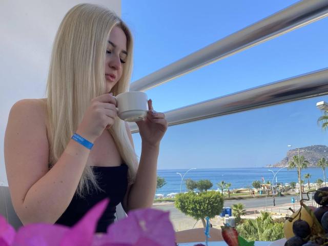 Flat, minimalist design with a large, white, uppercase letter "E" centered. Surrounding the letter are smaller, dark-colored letters forming a semi-circle. Simple, bold colors and clean lines.