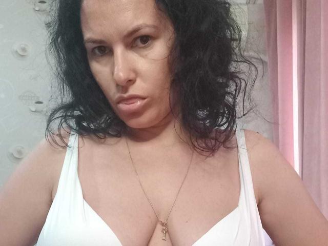 KinkyKosmina's pale skin, flat belly, and white ribbed panties with a pink "LORCN" tag. The panties sit just above her pussy.
