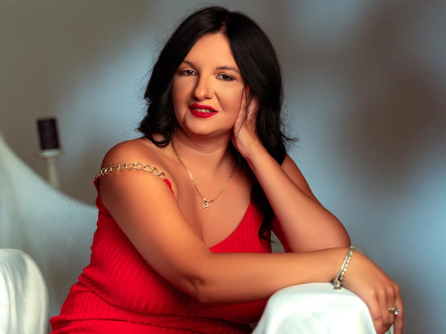 Digital art of a minimalist style, featuring a red and pink abstract shape in the center. The shape has a subtle, dark outline. Soft gradients and smooth textures dominate.