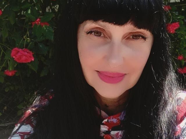 Flat, minimalist illustration of a red and white coat of arms with a small red emblem in the bottom right. Simple, clean lines with a central emblem and subtle shading.