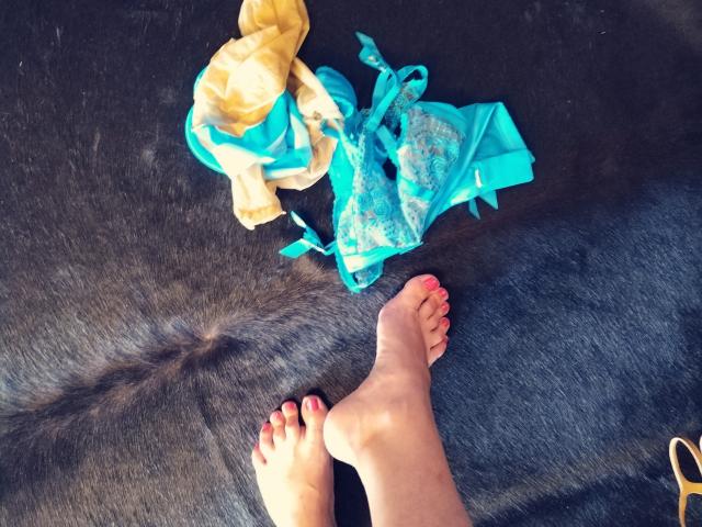 Digital art of a bold, stylized letter "V" in vibrant colors. The "V" has gradient blue, pink, and white sections. Sharp, clean lines with a minimalist design.