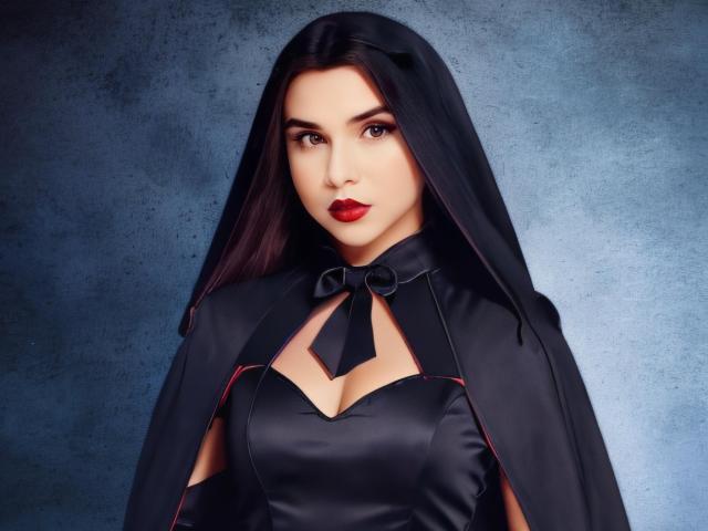 CamilaFetishDirty has dark hair, red lipstick, and is wearing a black veil with a matching dress showing her tits. She's looking serious with a blue textured background.