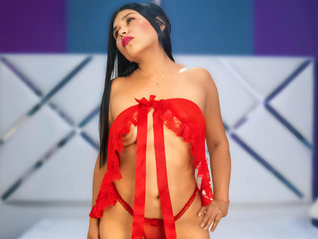 AgathaPember with long black hair, red lingerie with ribbon, showing small tits, red panties, standing, looking up, pink lipstick, red ribbon, red bow, tan skin, bedroom.