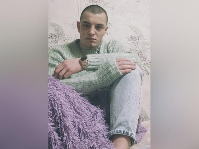 A large, flat, rectangular emblem with a dark brown, red, and white pattern. Centered, bold, and slightly raised. Simple, clean design. No visible textures or additional elements.