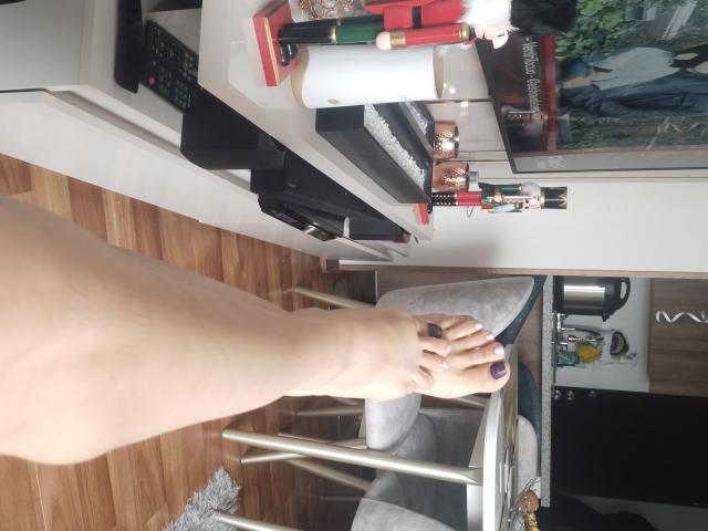 Digital art of a minimalist style featuring a large, bold, white letter "V" with a red accent in the top right corner. The letter is centered with clean, sharp edges.