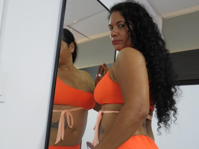 digital illustration of a red, white, and blue flag with a bold, symmetrical design. flag has a central emblem with a small white emblem at the bottom right.