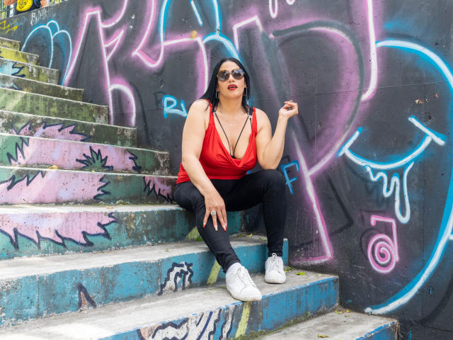 Digital art of a bold, modernist-style logo. Features red, blue, and white geometric shapes. Lined, flat colors. Simple, clean design with a slight 3D effect. Minimalistic.