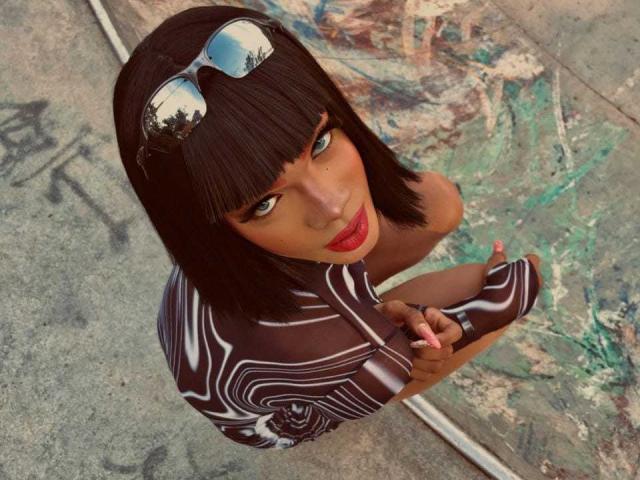 NaomiSteward with dark brown bob, reflective sunglasses on head, red lipstick, striped brown and white top, holding phone, looking up, standing on concrete, graffiti in background.