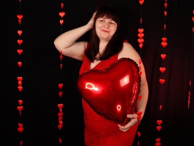 AliceInks, chubby, red dress, holding shiny red heart-shaped balloon, hand in dark brown hair, black background with red heart strings, slight smile, cute, soft lighting.