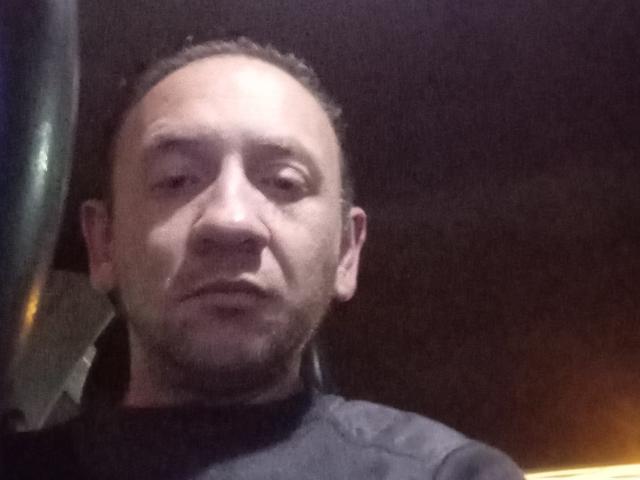 Erick69 has a bald head, light skin, and a short beard. He's wearing a dark shirt and looking slightly to the side with a neutral expression.