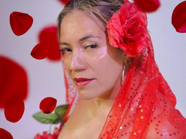 JadeSexiest with red rose in hair, red sequined veil, and red lipstick, surrounded by floating rose petals, has a cute, sexy, and slightly shy expression.