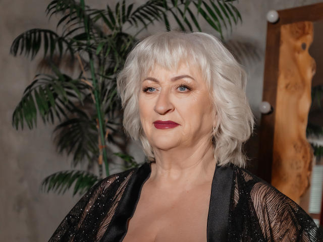 Digital illustration of a medieval-style coat of arms with a bold, red "V" centered on a dark, rectangular background. Simple, geometric lines and a solid color palette.