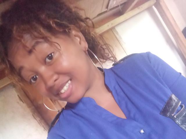 Digital art of a bold, stylized coat of arms with a light pink and dark blue color scheme. RichyFanya's emblem features a simple, flat design. Minimalistic, no intricate details.