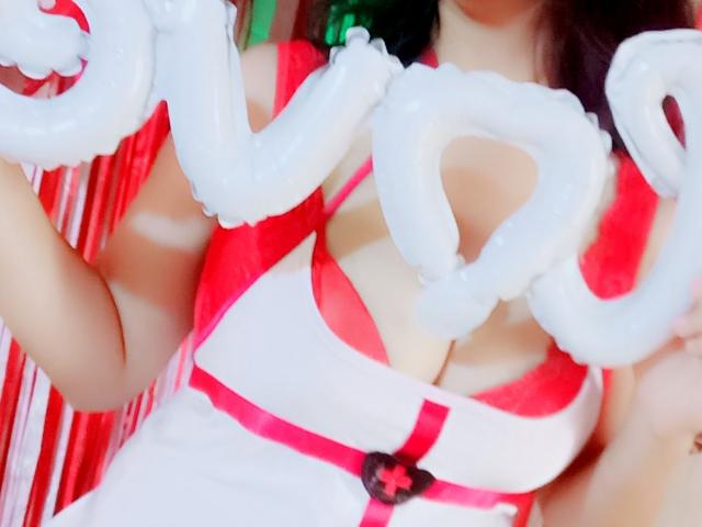 AngelahSexyXx com tentáculos em forma de balões brancos, vestindo um vestido vermelho e branco, mostrando seus seios. Fitas vermelhas e uma fivela de coração preto acentuam seu peito..