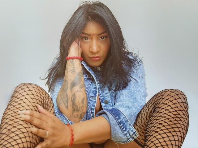 A flat design illustration of a large, stylized letter "A" in a bold, red-orange color. The letter has a blue and white pattern on its right side. Minimalistic, geometric style.