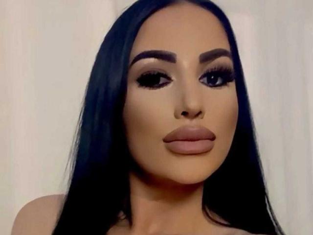 SexyAlyssa has long black hair, thick eyebrows, big dark eyes with long lashes, and full, pouty lips. Her skin is tan, and she's staring directly at the camera.