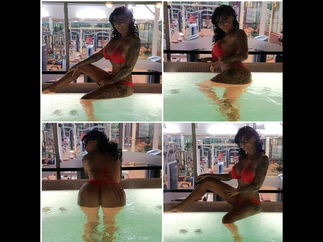 Sari-Sander with tattoos, wearing a red bikini, sitting in a pool, showing her butt, legs, and tits, with curly hair and glasses, in four different poses.