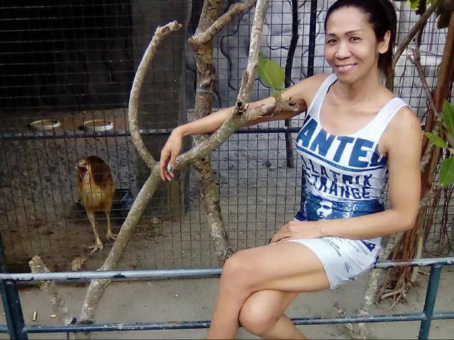 xUrDestinyTS69x-hot, white tank top, "AMITE" and "BLACK TANK" text, white mini-skirt, blue belt, brown hair, smiling, sitting on tree branch, bird in cage behind.