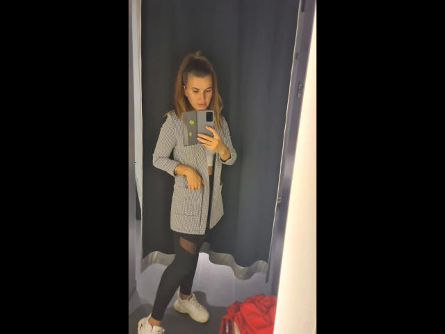 Xxjessa-hot in a grey plaid coat, black leggings, and white sneakers, taking a mirror selfie with a serious expression, holding a smartphone.