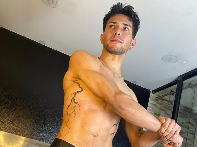 Digital art of a medieval-style banner with a red and black design. Central red and black shapes with a small black emblem at the top. Soft gradient colors.