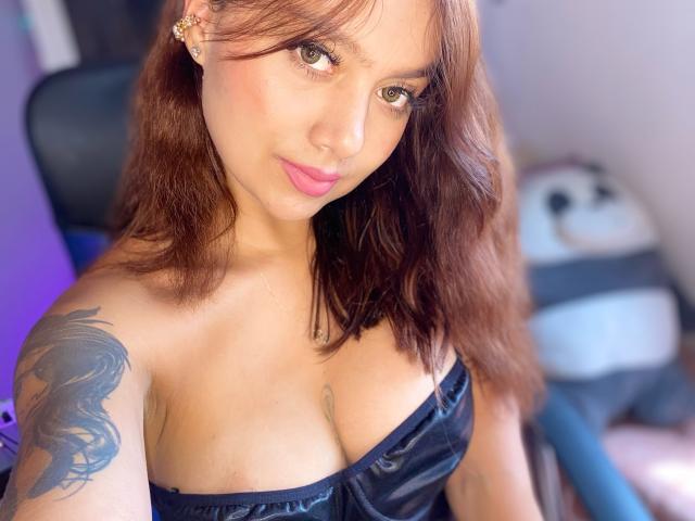 Digital illustration of a stylized, minimalist letter "V" in a bold, flat design with a light pink-orange gradient. Simple, clean lines, and a subtle shadow for depth.