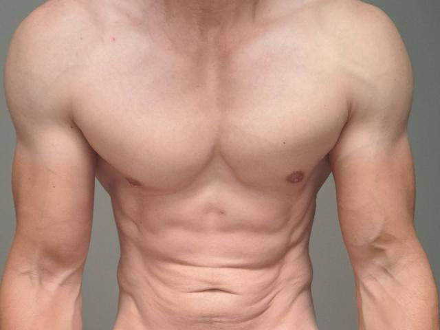 AtleticoMaduro's muscular, bare chest with visible abs and small, dark nipples. Their skin is light, and their arms are slightly flexed, showing defined muscles.