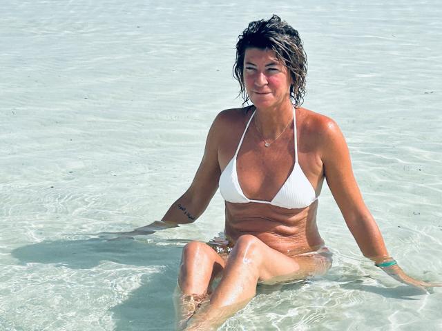 A digital illustration of a red flame-shaped emblem with a black and red design in the center. Simple, bold colors. The emblem is centered with a slight shadow.