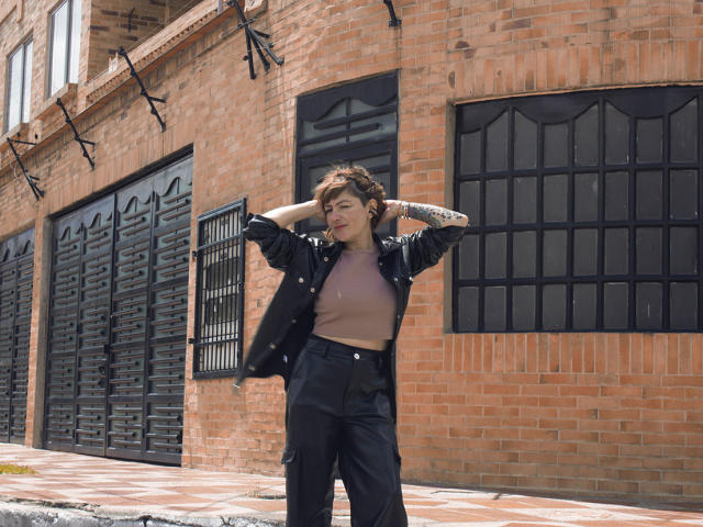 Minimalist illustration of a dark, bold, and simple design with a central, flat, dark brown symbol. Flat colors, solid shapes, and clean lines dominate. MaferCougar is not visible.