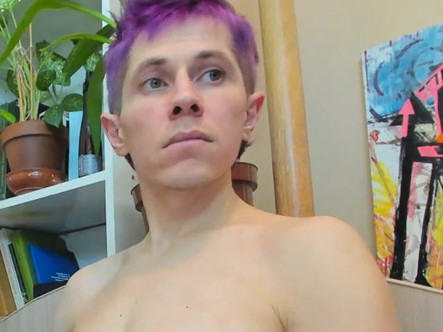 VioletaAndLeo, shirtless with purple hair, fair skin, small ears, and a serious face, in a room with a potted plant and abstract painting.