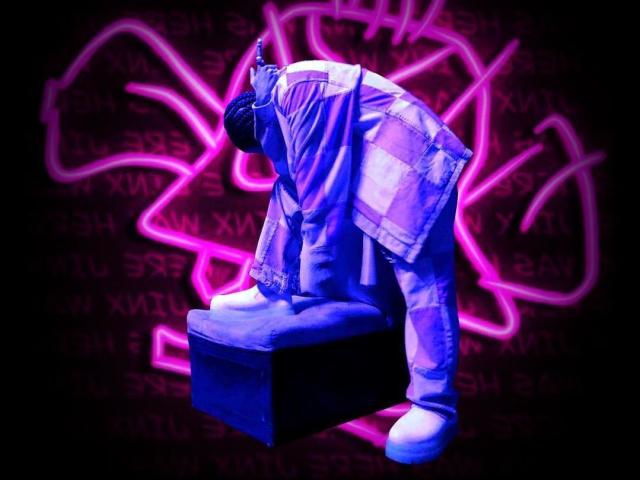 RebelDali69 is a blue-toned, clothed statue with a baggy, checkered outfit and white sneakers, kneeling on a dark block, in a neon pink, glowing background.