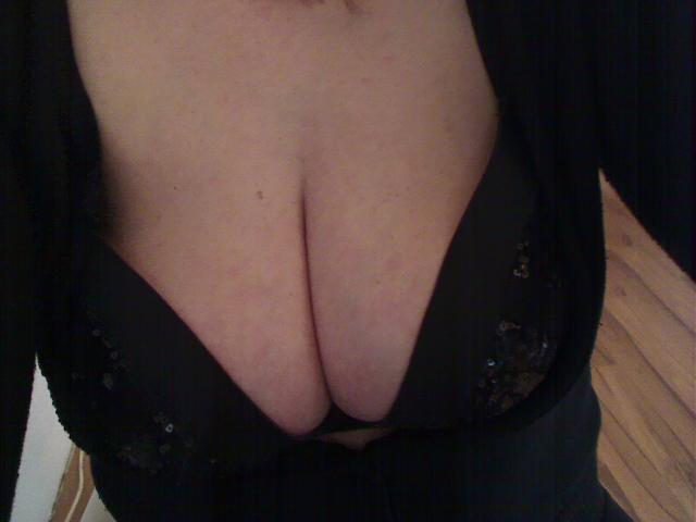 Lissy-Privat-hot's big, round, ample tits in a black, sequined bra, showing a deep cleavage with pale skin and a black top partially covering her chest.