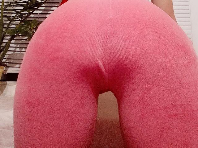 DianaFetishX-hot's pink ass in tight, textured pink leggings, centered in the frame, showing a subtle butt crease and the bottom of her back.