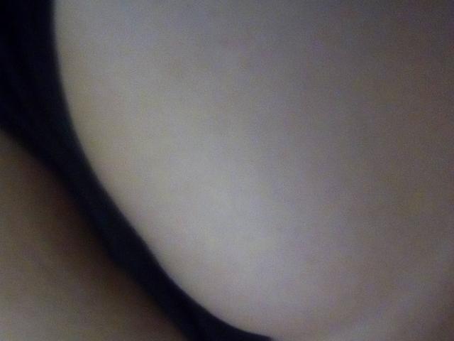 MindyTaylor's bare ass, with a black thong partially visible on the left side, in a slightly blurred, close-up shot.