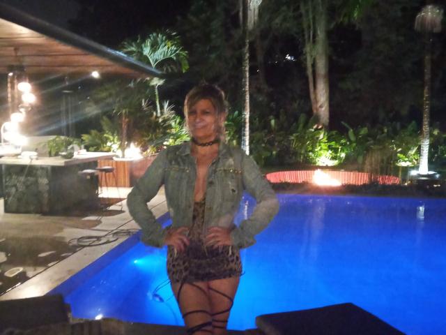 A flat, minimalist illustration of a coat of arms. Central, bold white emblem with red and green accents. Simple, clean lines. No intricate details or textures. Basic color palette.