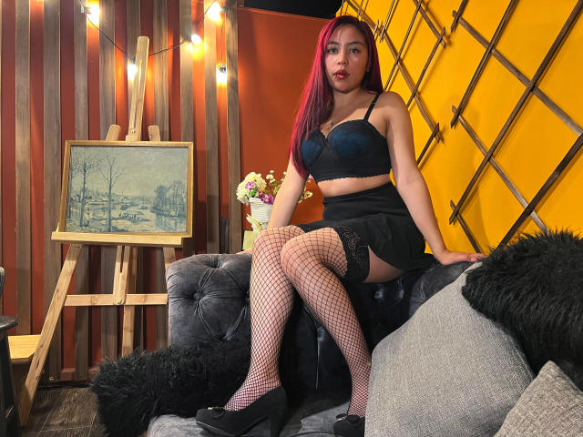 Digital art of a geometric design with overlapping orange and black shapes, featuring a prominent diagonal line in the top right. Grid-like pattern in the bottom right. Bold, flat colors.