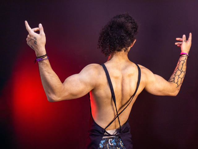 Digital art of a minimalist, flat-style design. Features two large, overlapping, pale red and white letters "P" in the center. Simple, clean lines and no additional elements or textures.