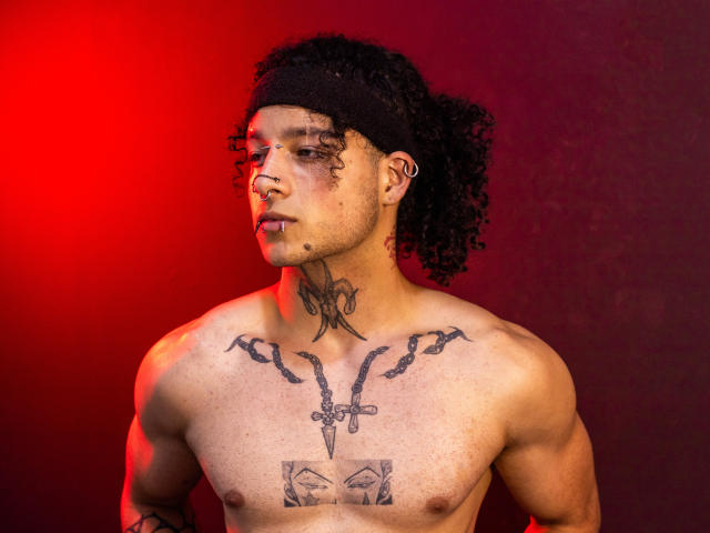 Red and white paper cut-out of a coin, centered with a black emblem. Simple, flat design with clean lines. No textures or shading. Bold colors, minimalistic style.