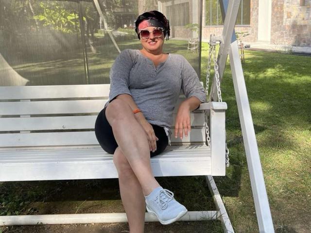 A minimalist, digital illustration of a stylized, red and white coat of arms with bold, geometric shapes. The design features clean lines and a flat color palette.