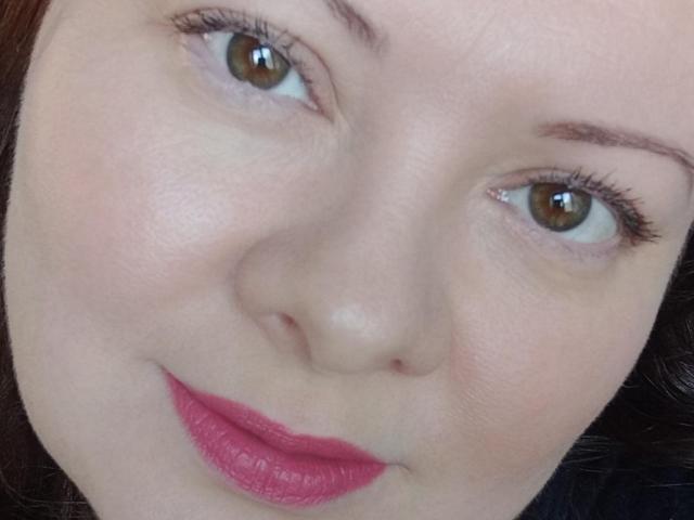 MayDreamy's face, showing pale skin, brown eyes, pink lipstick, and slightly parted lips, with dark brown hair and subtle makeup. Her expression is gentle and slightly smiling.
