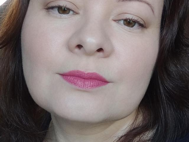 MayDreamy's face, showing pink lipstick, brown eyes, and dark brown hair. She has a slight smile with her nose and lips centered in the shot. Her skin is fair.