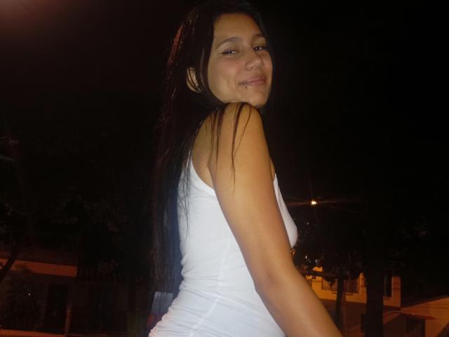 A close-up of a baroque-style coat of arms. The design includes a central red flame with orange and yellow gradients, surrounded by a white border. The flame is slightly tilted.