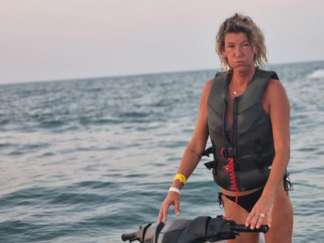 Digital illustration of a stylized Korean flag with red and white colors. Bold red stripes on both sides, white triangle in the center. Simple, clean design. Flat colors.